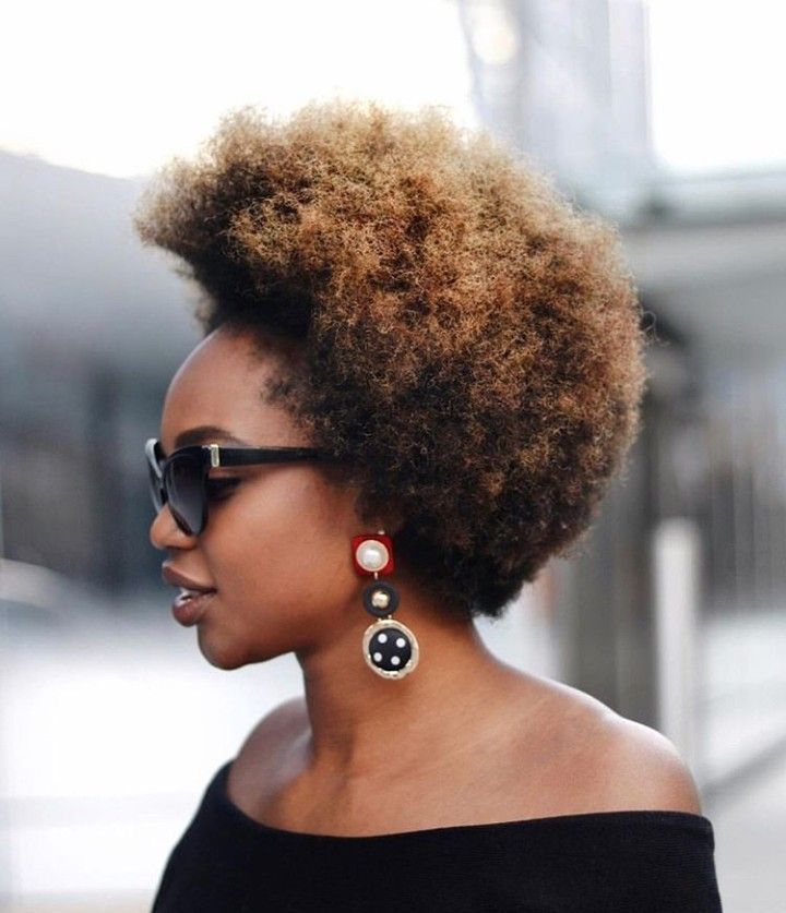 someone with mini afro with statement earrings date night hairstyle for afro hair