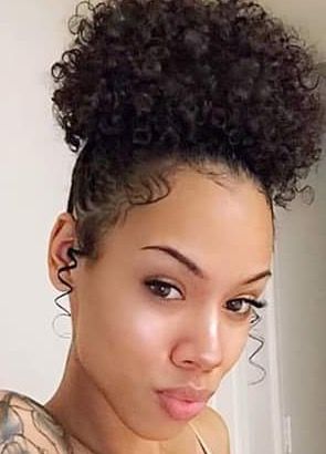 someone with pineapple puff with face framing curls