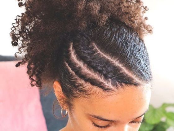 someone with puff with side braid accent