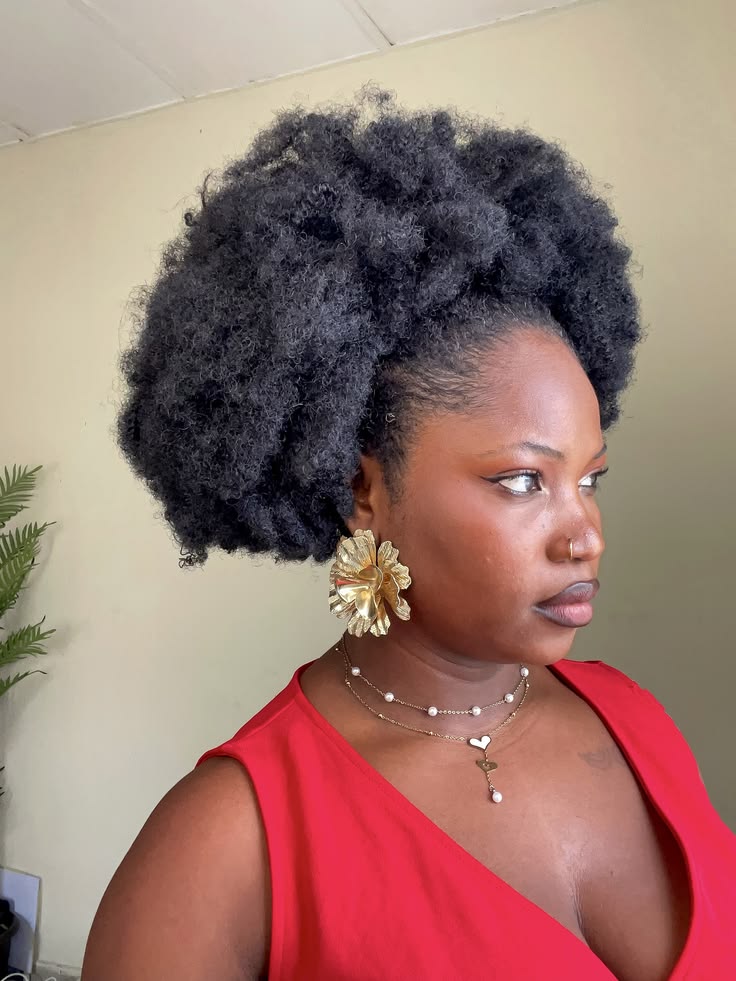 someone with puff with statement earrings
