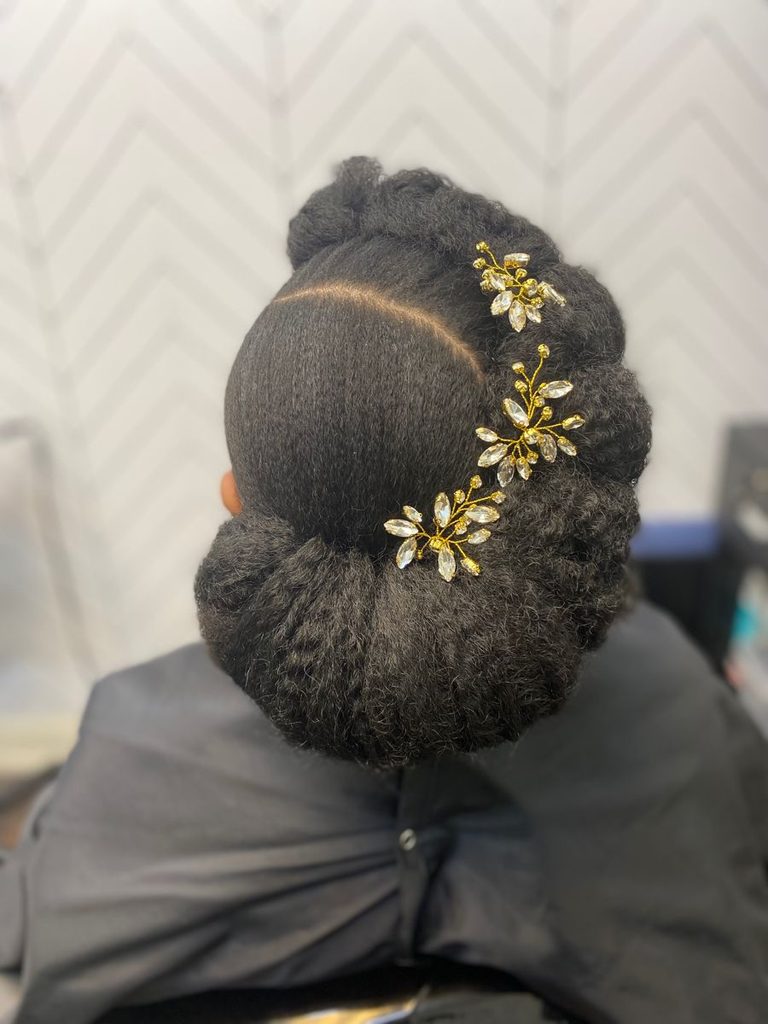 someone with rolled and pinned natural updo