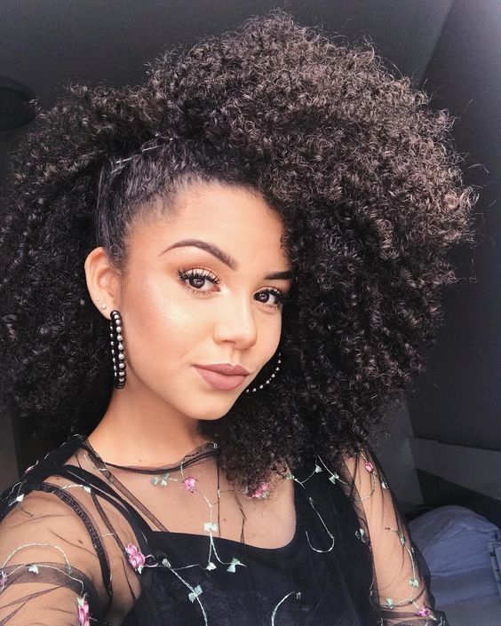someone with side swept frohawk date night hairstyle for afro hair