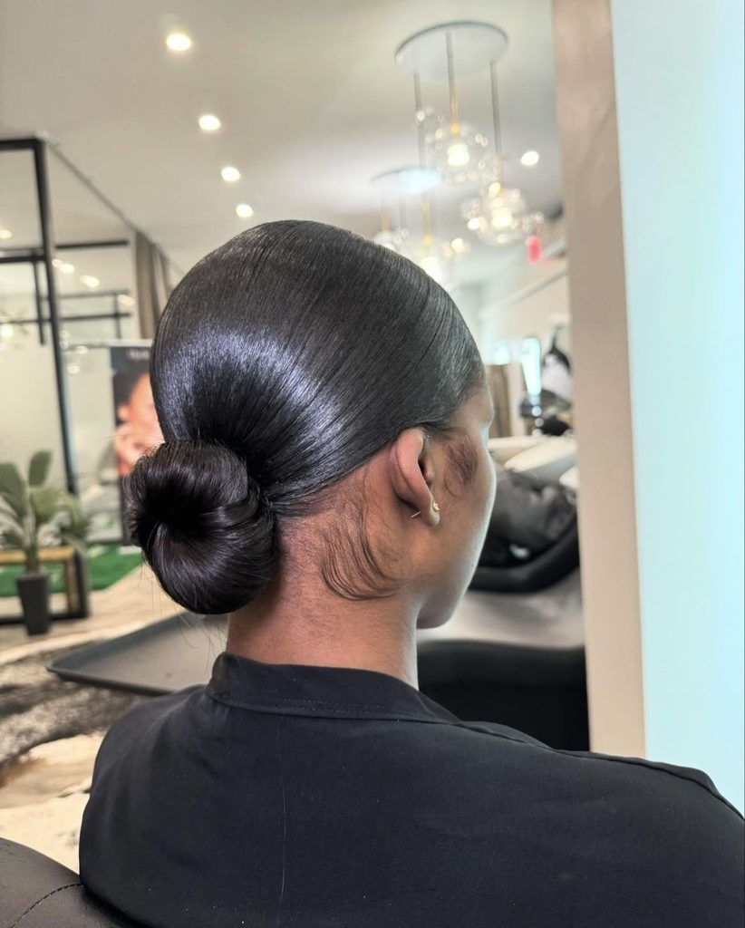 someone with silk press with bun hairstyles for the office