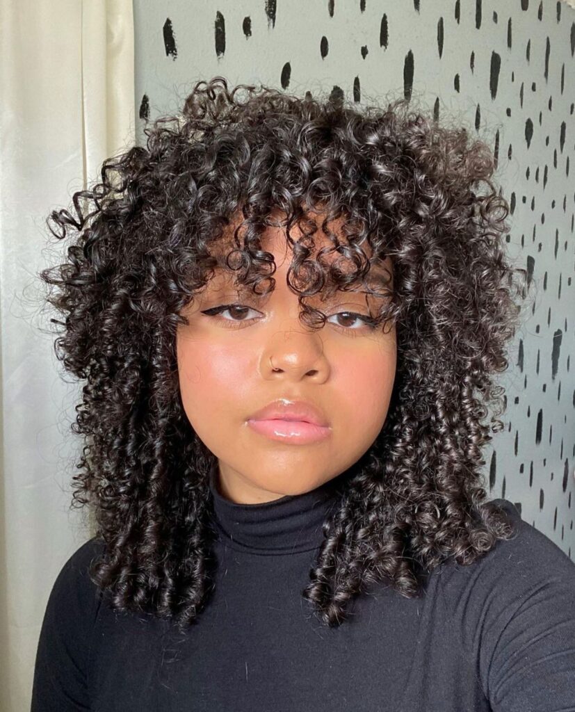 someone with soft curl hair shag