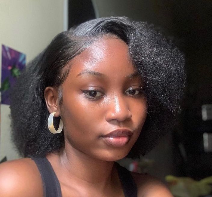 someone with stretched afro with a deep side part