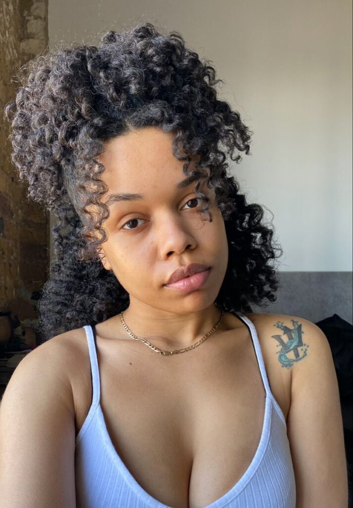 someone with twist out half up half down