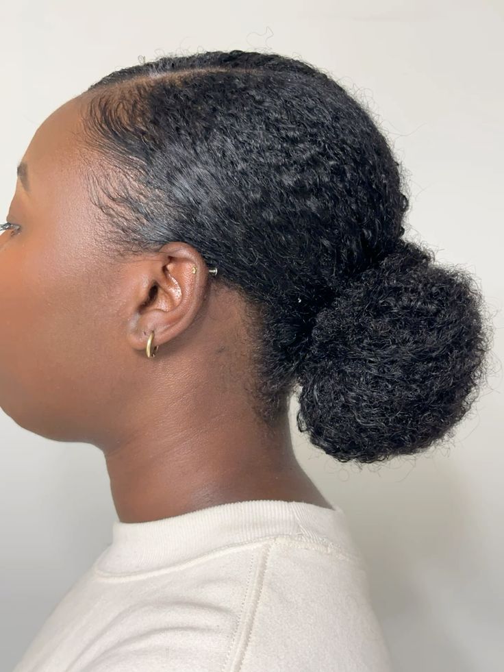 someone with twist out low bun