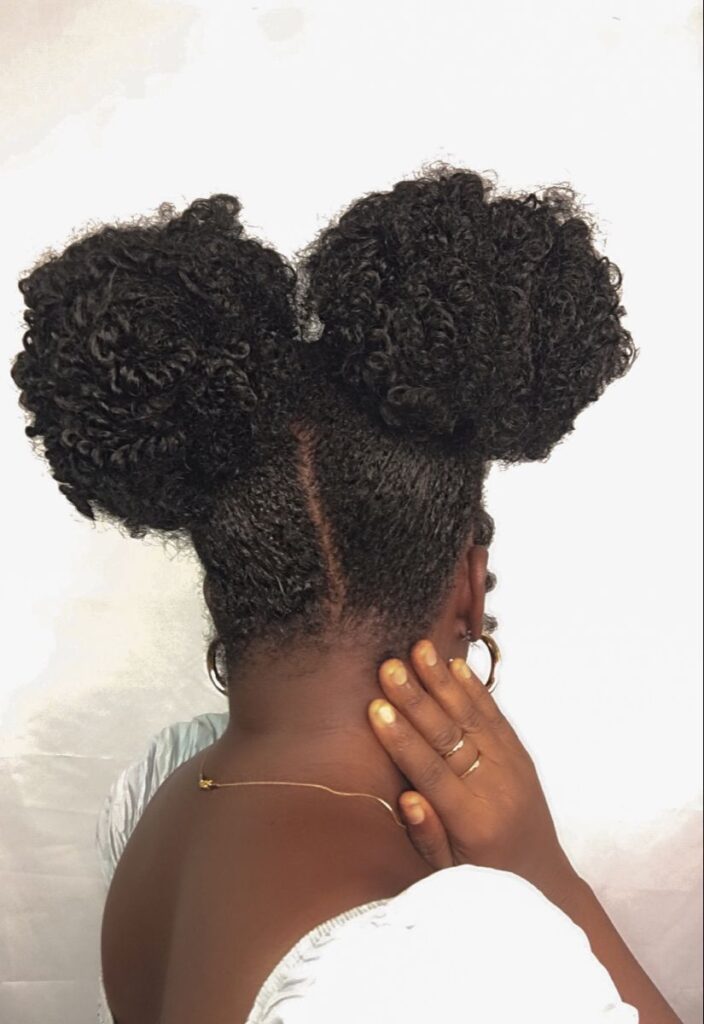 someone with twist out space buns
