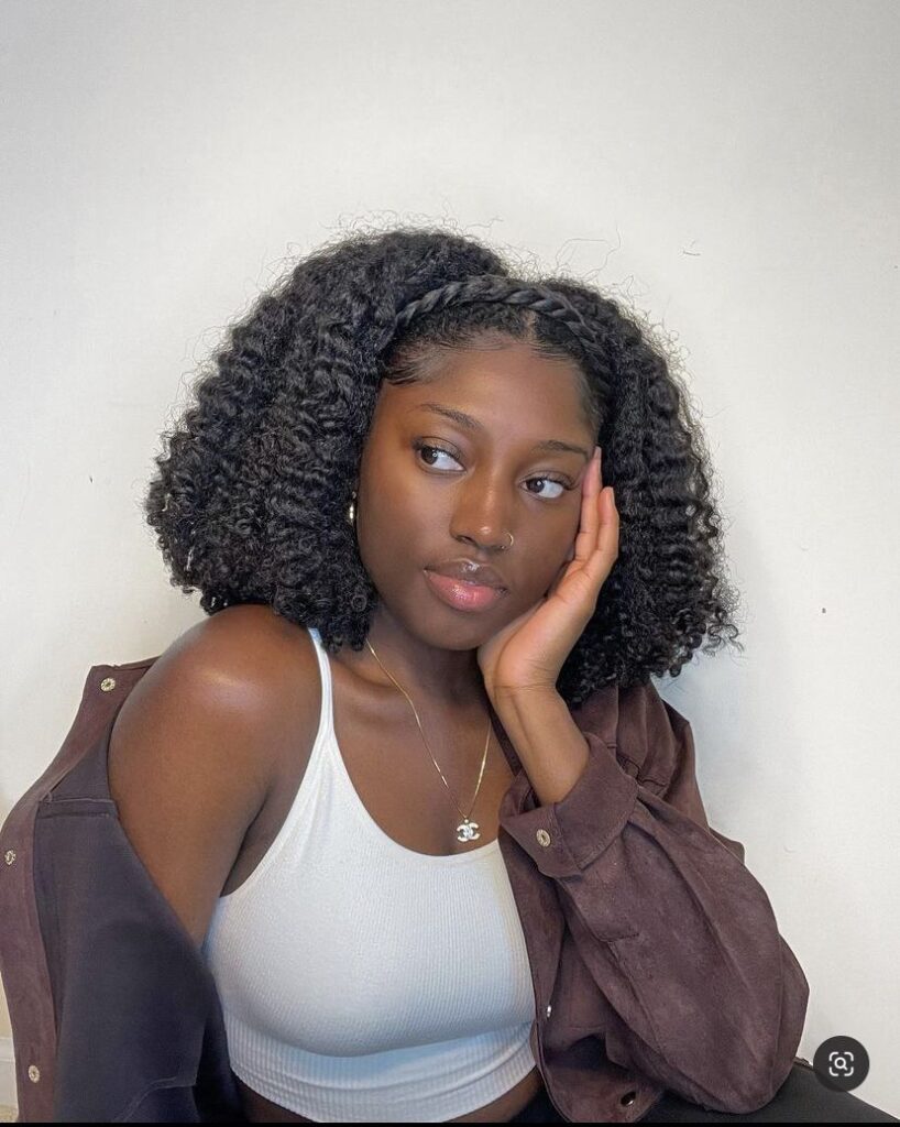 someone with twist out with braided crown