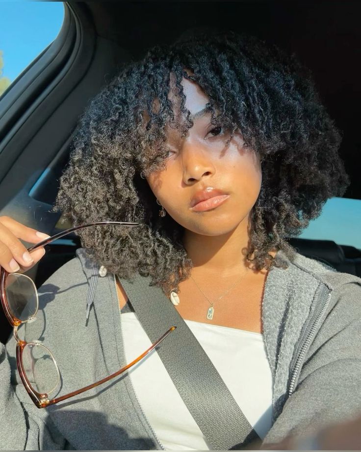 someone with twist out with curly bangs