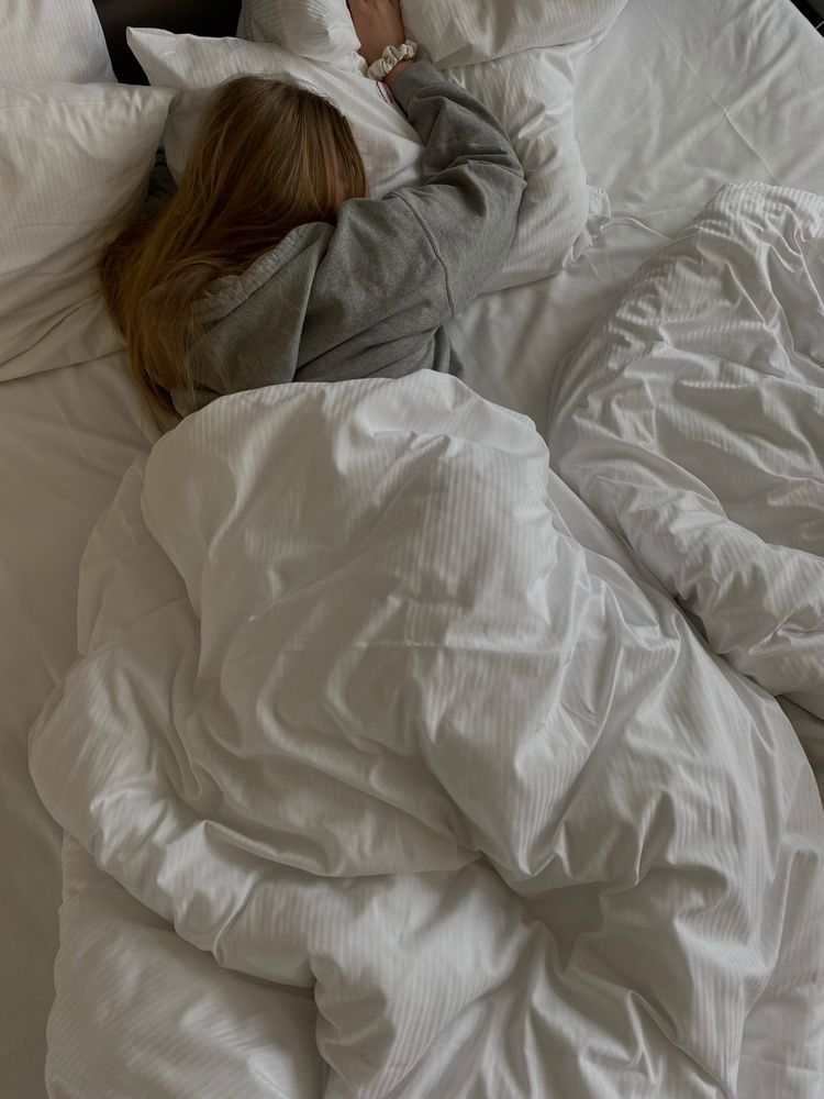 a girl sleeping on a cotton pillow without hair cover as one of the hidden mistakes that's breaking your hair every week