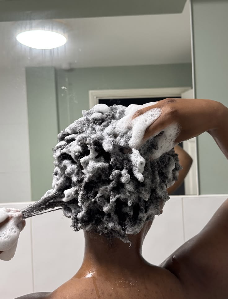 someone washing her hair on her hair wash day