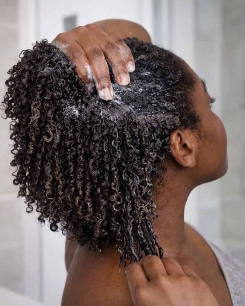 someone deep conditioning her hair on her 4A hair wash day