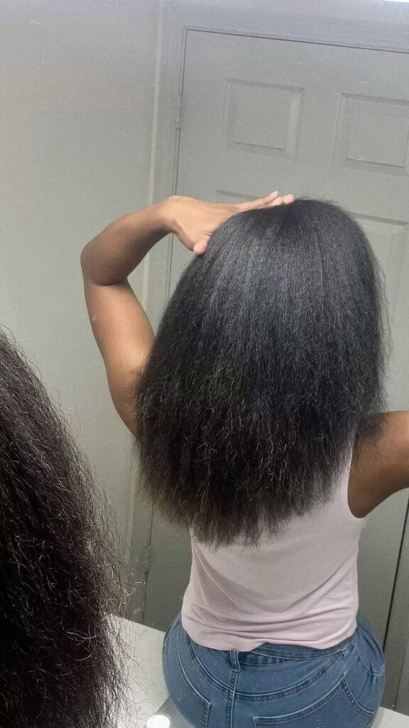someone watching her blow out hair through the mirror
