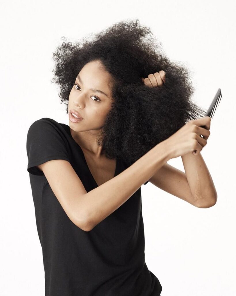 someone combing her dry hair