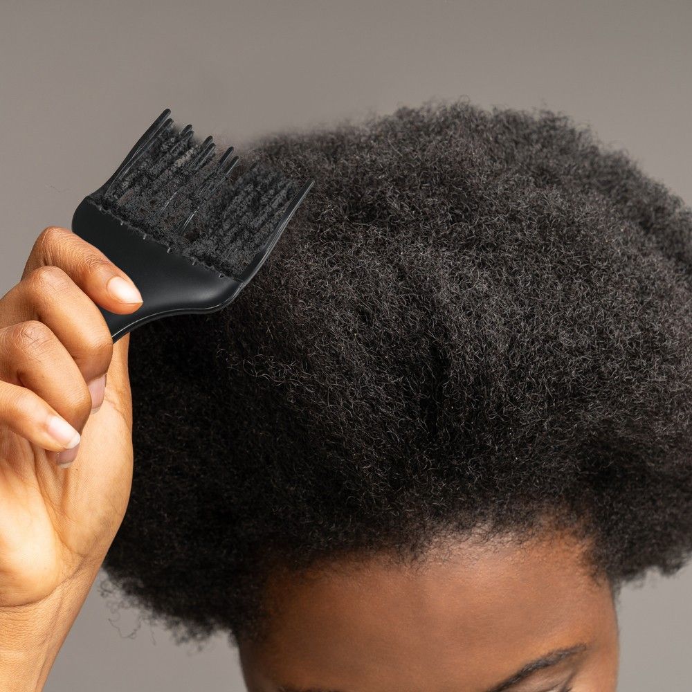 someone that is combing her hair