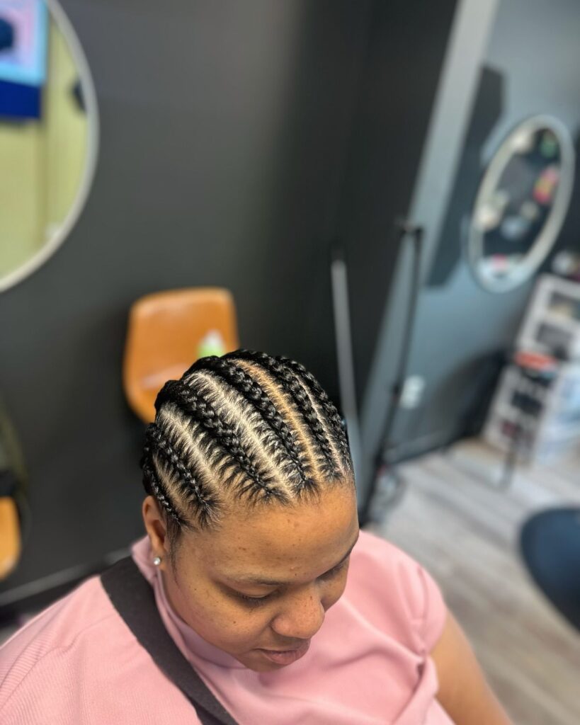 someone with cornrows protective hairstyle as a way to prep hair before installing a wig