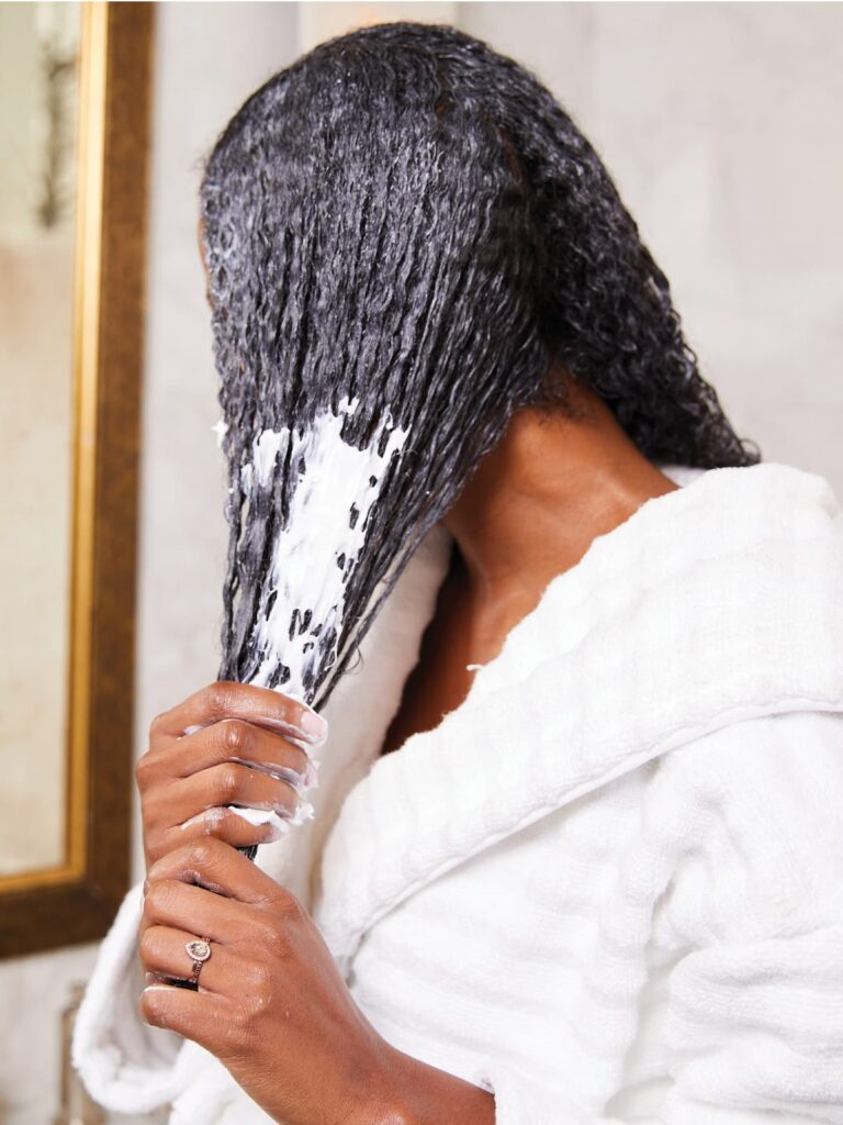 someone deep conditioning her hair