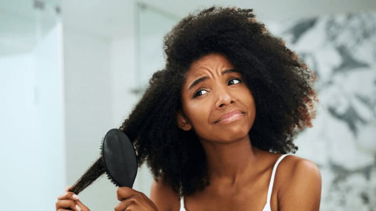 someone detangling hair with force
