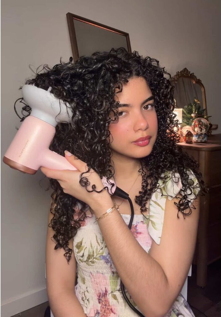someone drying her hair using hair diffuser
