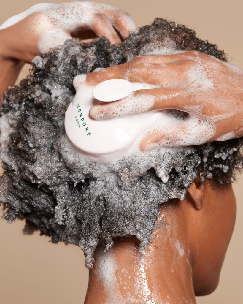 someone scrubbing and washing her hair