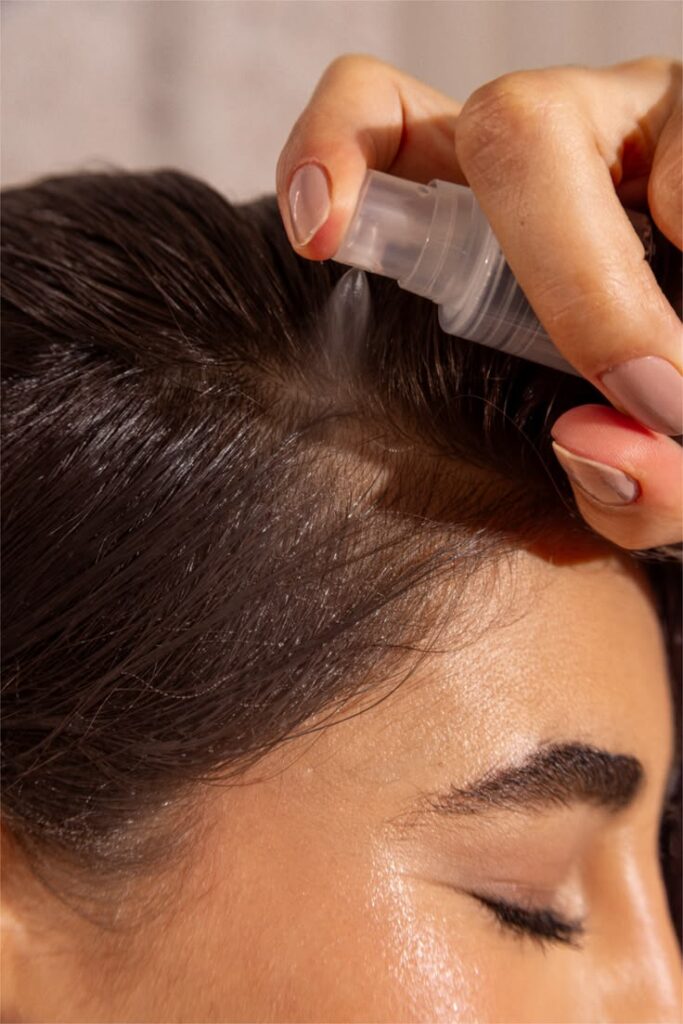 someone spraying hair product