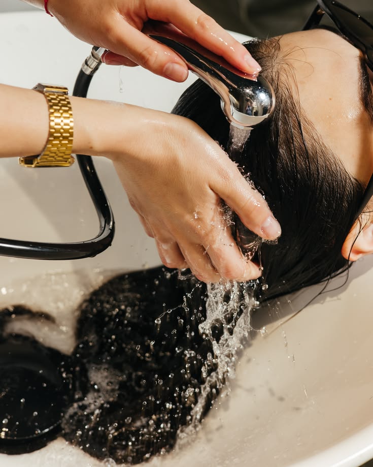 someone washing her hair
