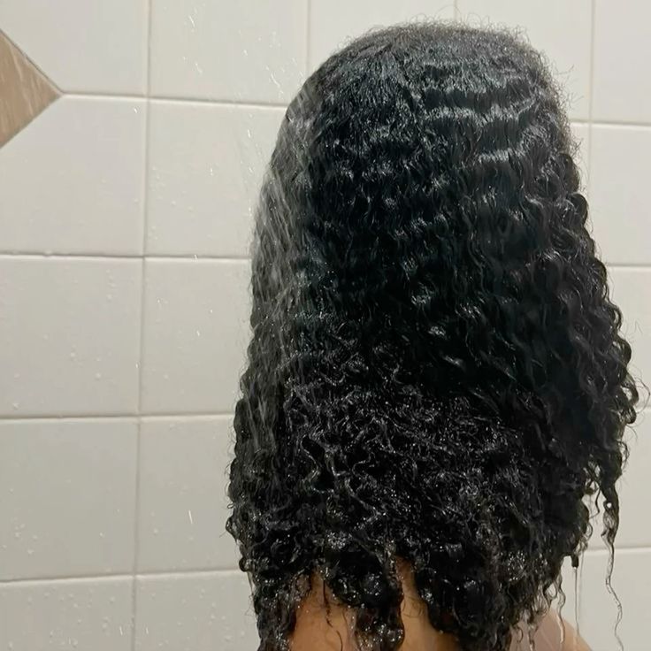 someone washing hair in bathroom shower on her 4B hair wash day