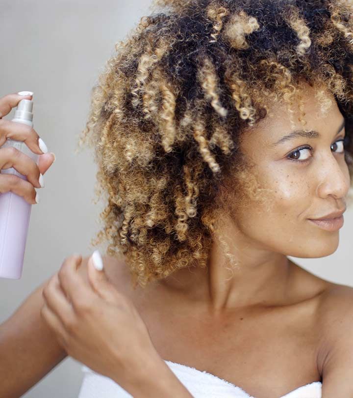 someone applying heat protector to dry hair