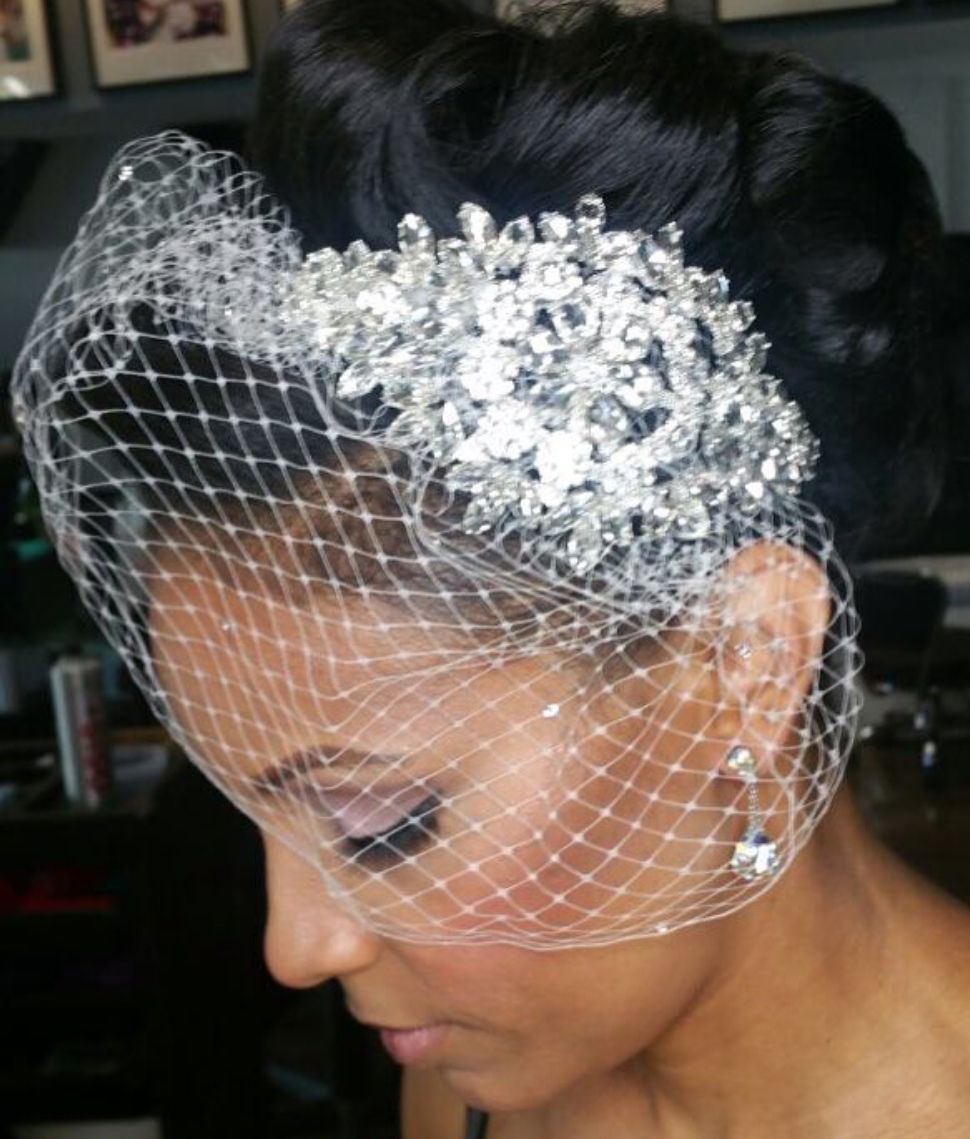 lady with high buff with birdcafe veil