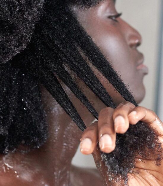 someone pre-poo her hair as one of the ways to shorten your wash day