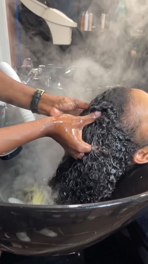 someone washing and massaging her scalp