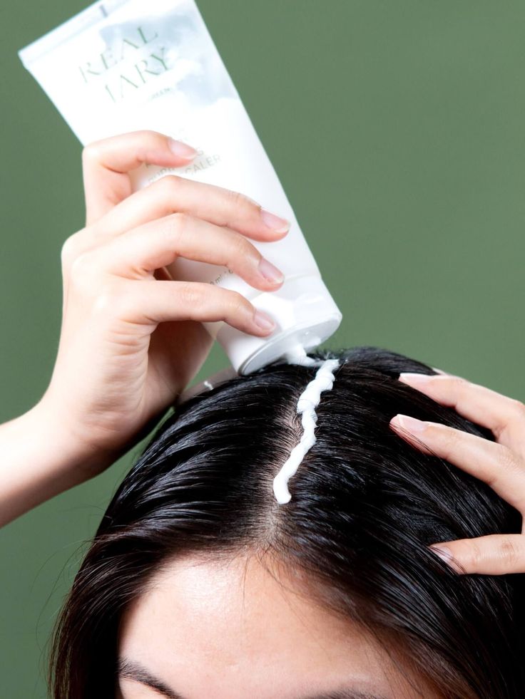 someone applying scalp product as healthy scalp habits