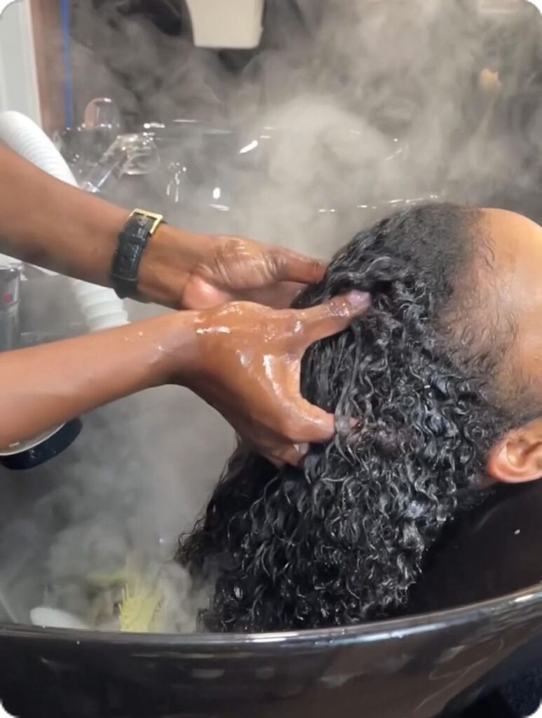 someone washing and massaging her scalp