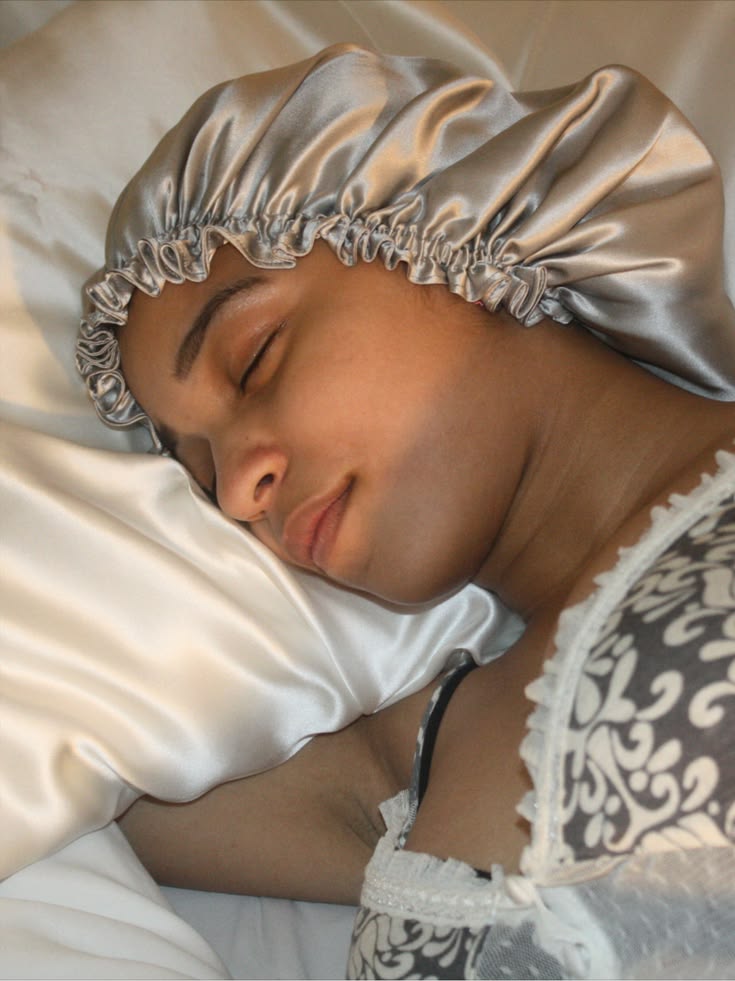 someone sleeping with silk bonnet and pillow case