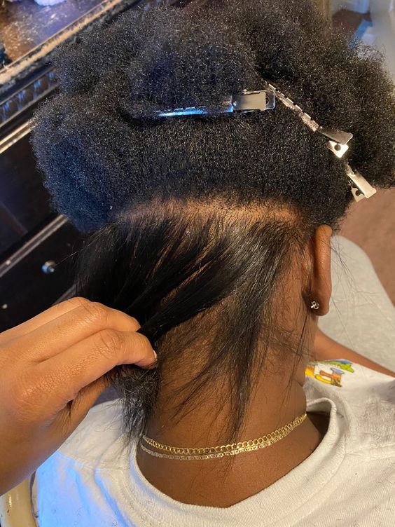 someone silk pressing her afro hair