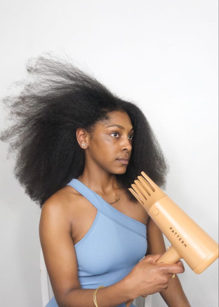 someone blow drying her afro hair without damage