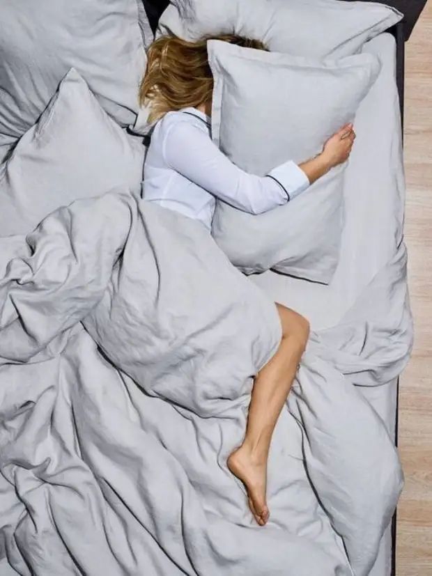 young lady sleeping on a cotton pillow without hair cover as one of the hidden mistakes that's breaking your hair every week