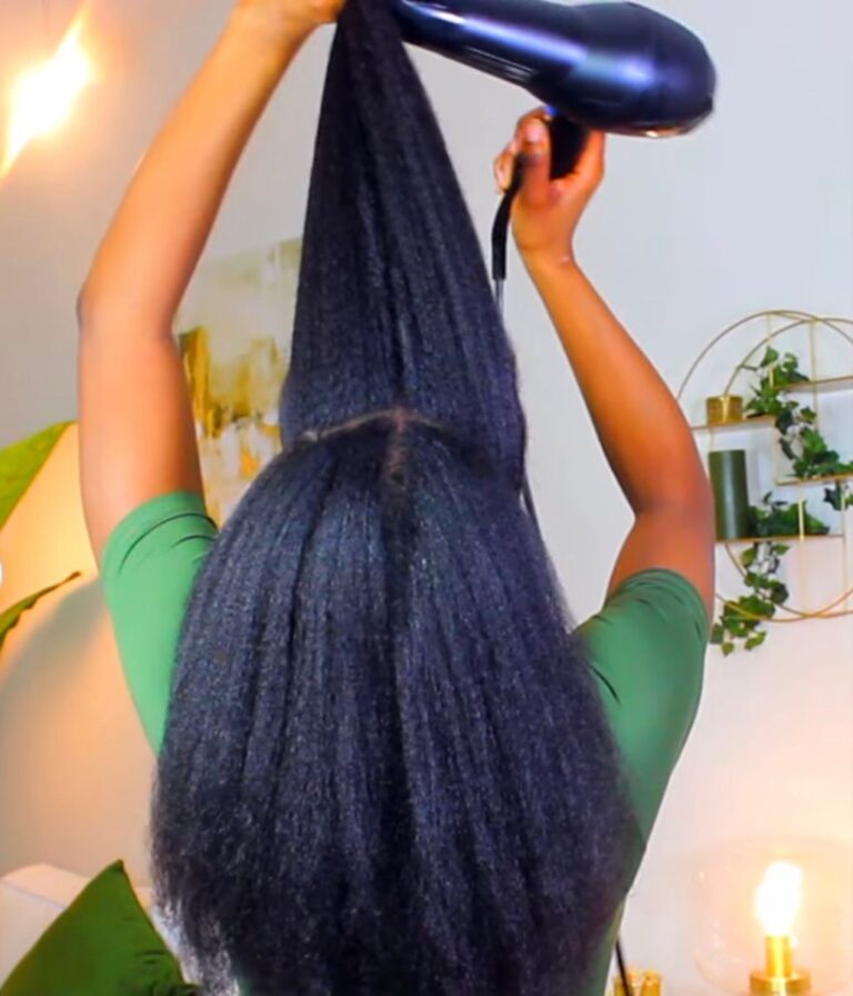 someone that is blow drying her hair