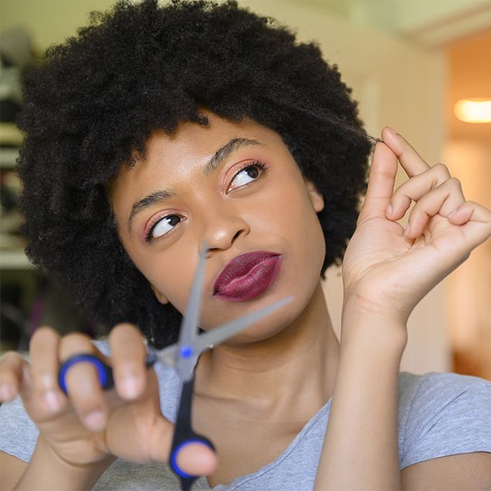 someone that is trimming her hair