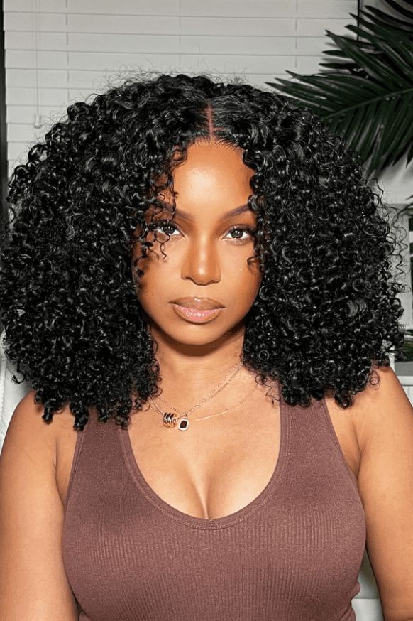 someone wearing curly wig over natural hair