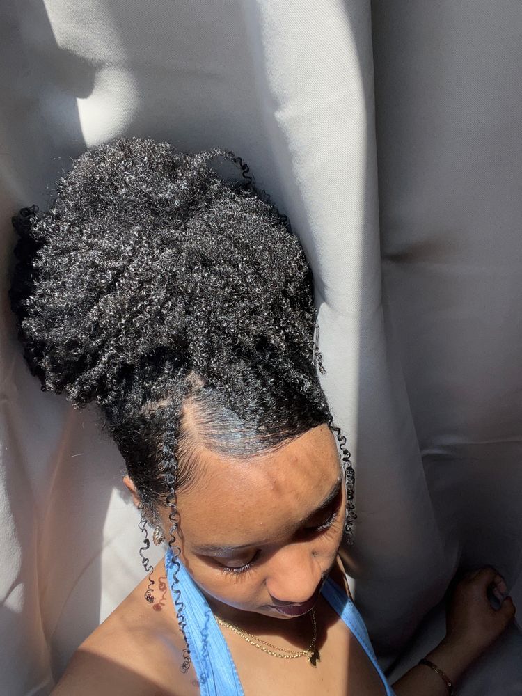 a girl with styled curly hair with some strands in the front