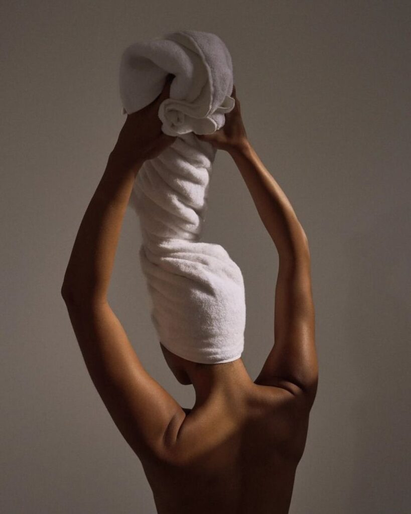 someone that is towel drying her hair