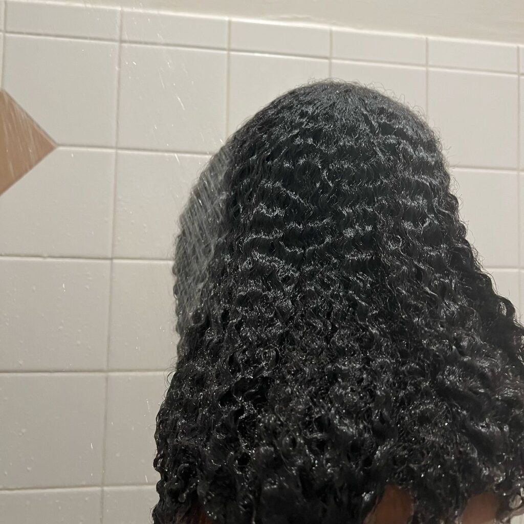 someone washing hair with bathroom shower