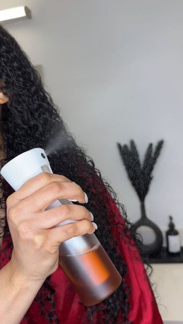 someone applying water spray to her hair