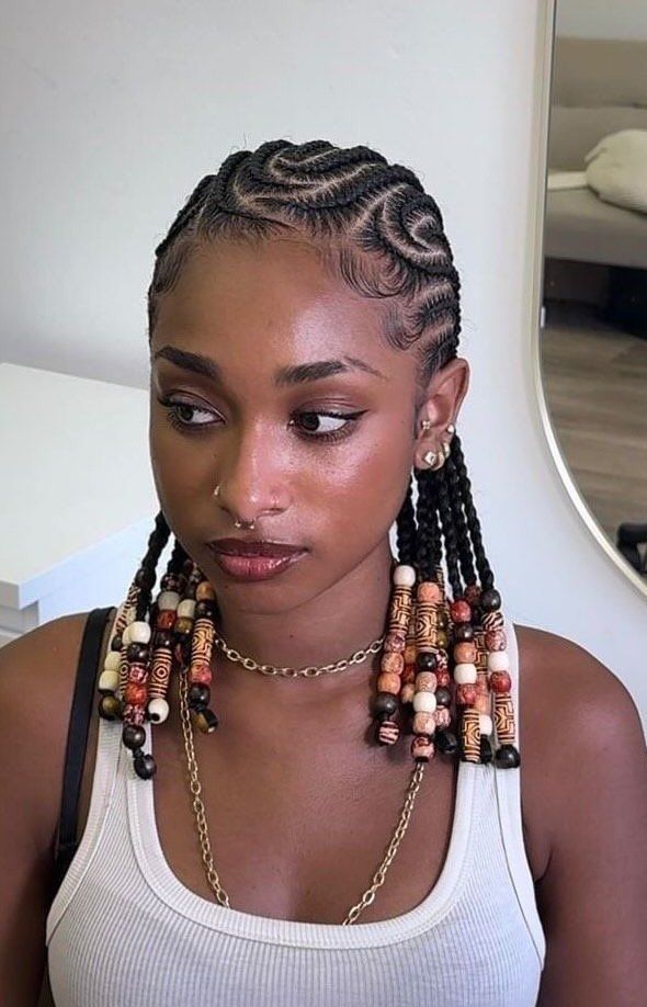 someone with beaded cornrow style