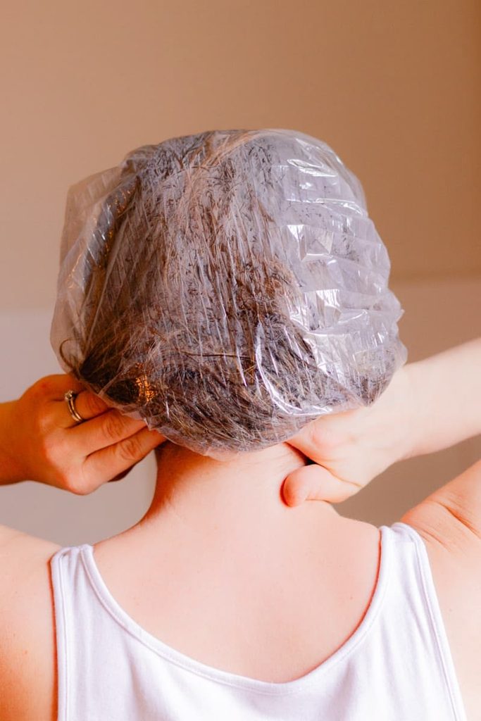 someone in deep conditioner cap