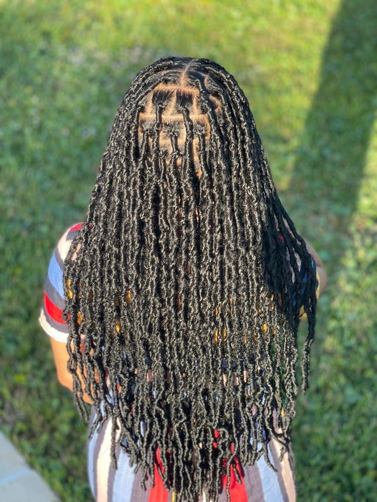 someone with distressed faux locs protective styles