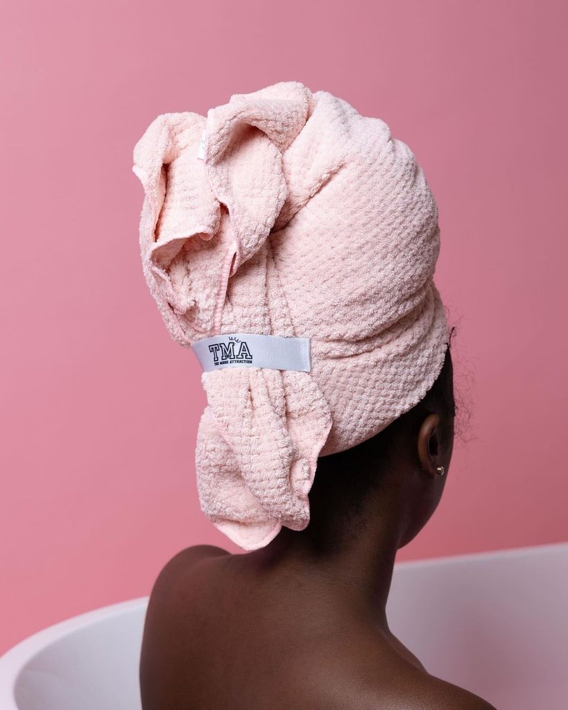 someone that's drying her hair with microfiber towel