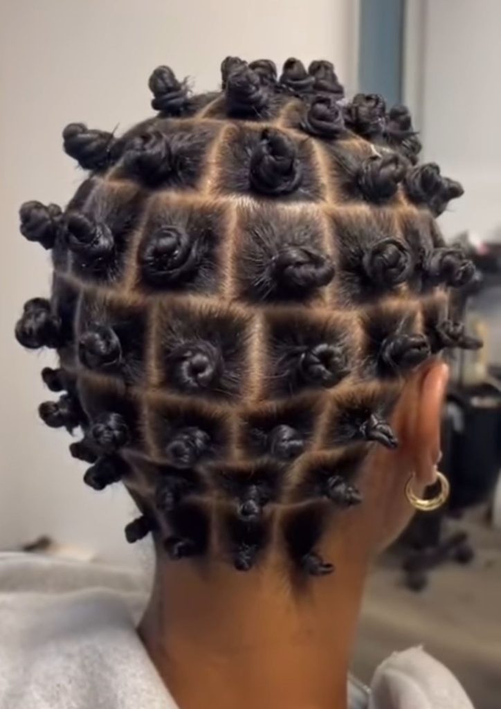 someone with short bantu knot set